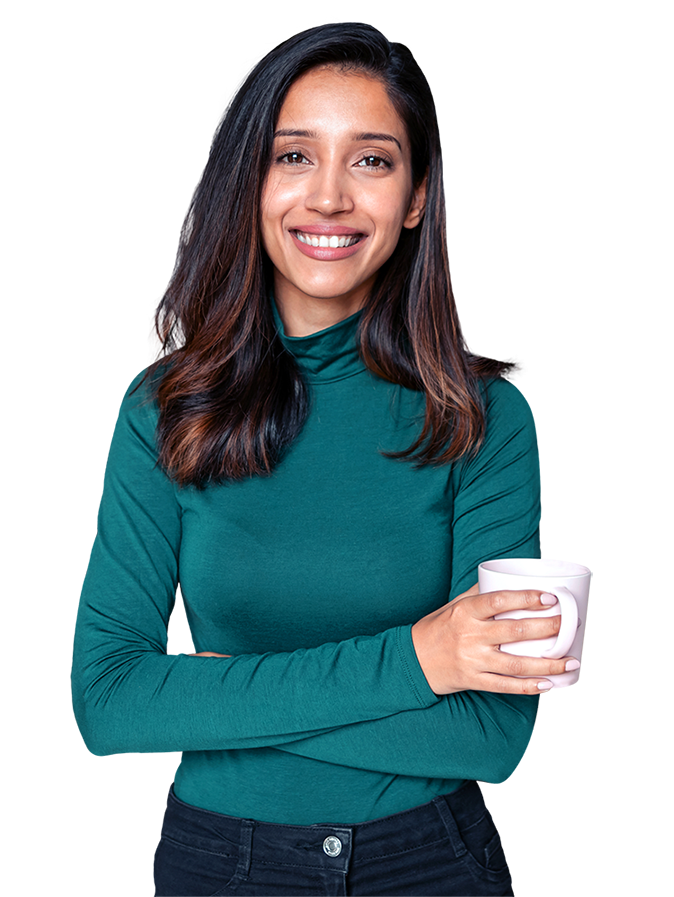 A person with long hair is wearing a long-sleeve turtleneck shirt and black pants, holding a mug in one hand with the other arm crossed over the body.