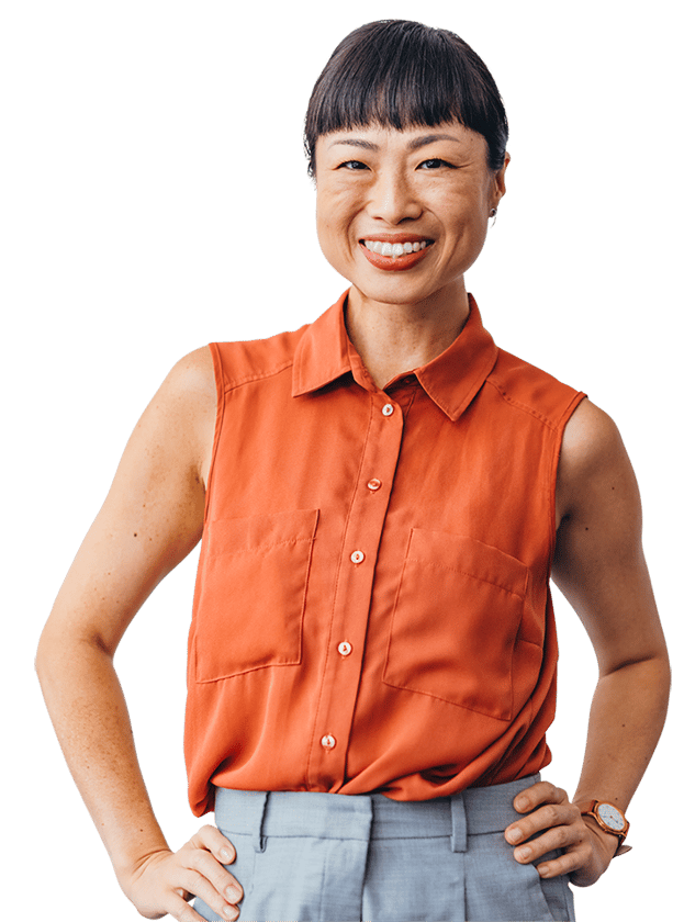A person is wearing a sleeveless button-up shirt with front pockets and light pants. One hand is on the hip, and the other rests by the side with a watch on the left wrist.