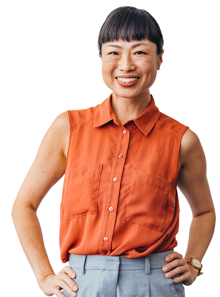 A person is wearing a sleeveless button-up shirt with front pockets and light pants. One hand is on the hip, and the other rests by the side with a watch on the left wrist.